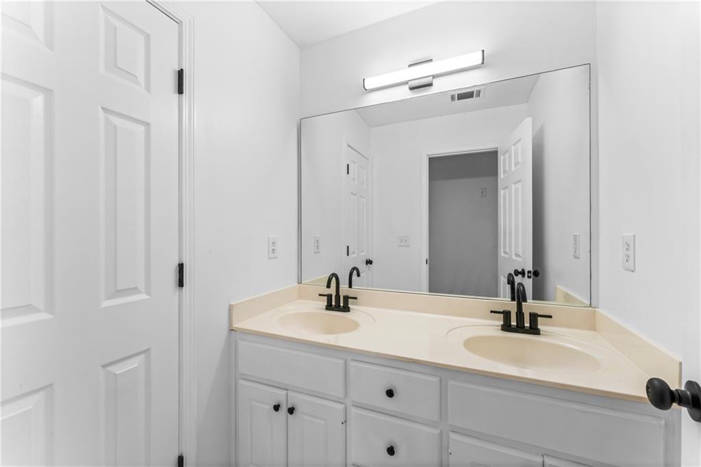 4267 Azalea Walk Ellenwood, GA 30294 - Photo 16 of 24 a bathroom with a sink and a mirror