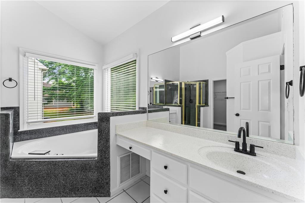 4267 Azalea Walk Ellenwood, GA 30294 - Photo 21 of 24 a bathroom with a granite countertop sink and a large mirror