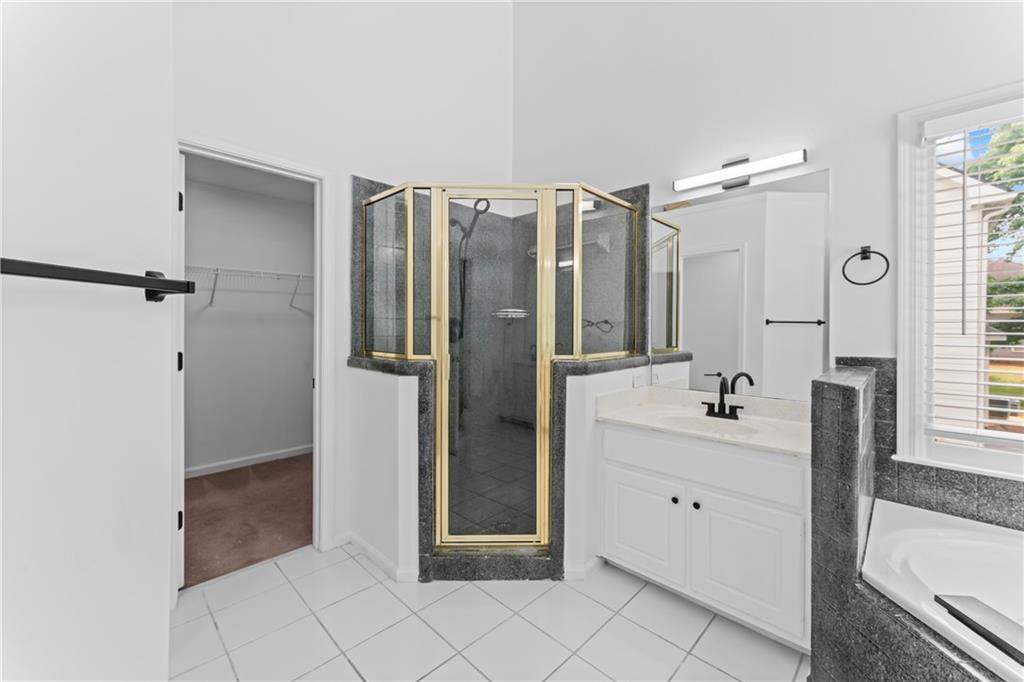 4267 Azalea Walk Ellenwood, GA 30294 - Photo 22 of 24 a bathroom with a double vanity sink toilet and shower