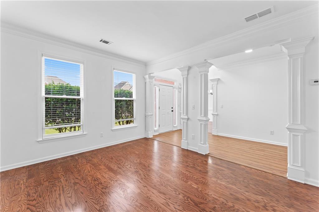 4267 Azalea Walk Ellenwood, GA 30294 - Photo 3 of 24 an empty room with wooden floor and windows