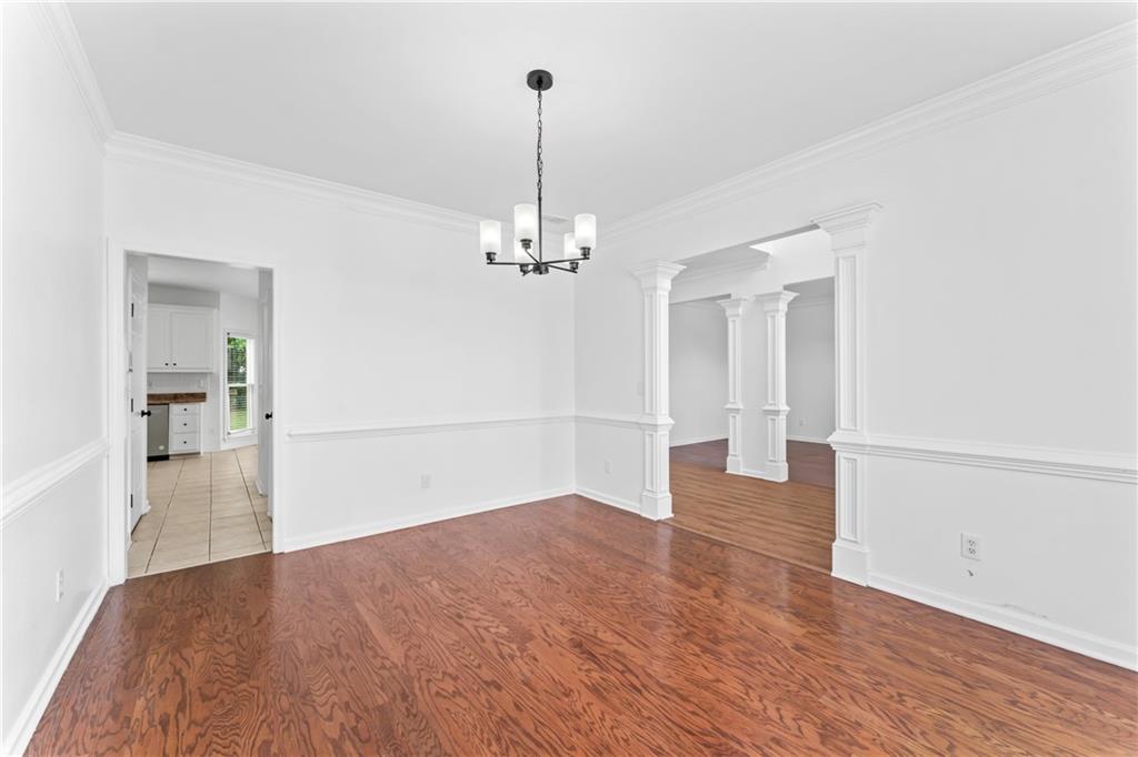 4267 Azalea Walk Ellenwood, GA 30294 - Photo 4 of 24 a view of a room with wooden floor staircase and a kitchen