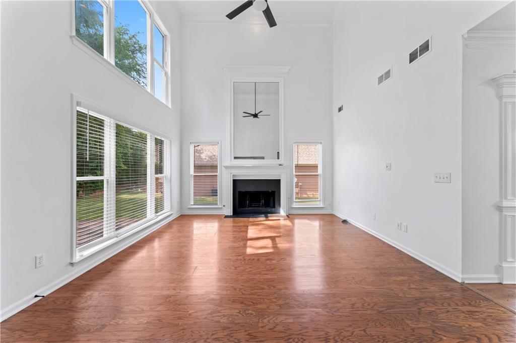 4267 Azalea Walk Ellenwood, GA 30294 - Photo 9 of 24 a view of a livingroom with wooden floor a fireplace and window