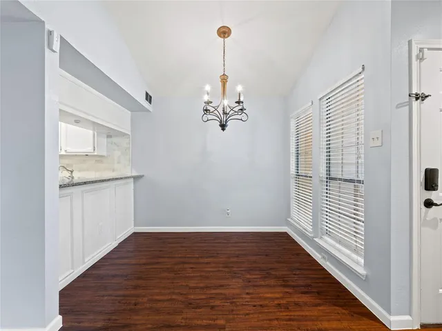 a view of a kitchen with wooden floor and a ceiling fan