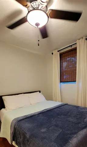 a bedroom with a bed and cabinets