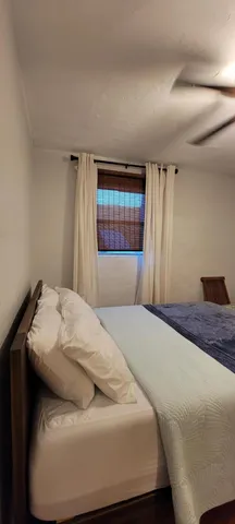 a bedroom with a bed and window