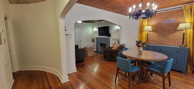 a view of a dining room with furniture and a chandelier fan
