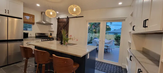 a open kitchen with a refrigerator a stove top oven a sink and dishwasher