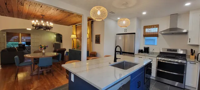 a kitchen that has a table chairs and a stove