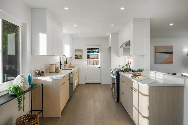 a kitchen with stainless steel appliances granite countertop a sink stove and refrigerator