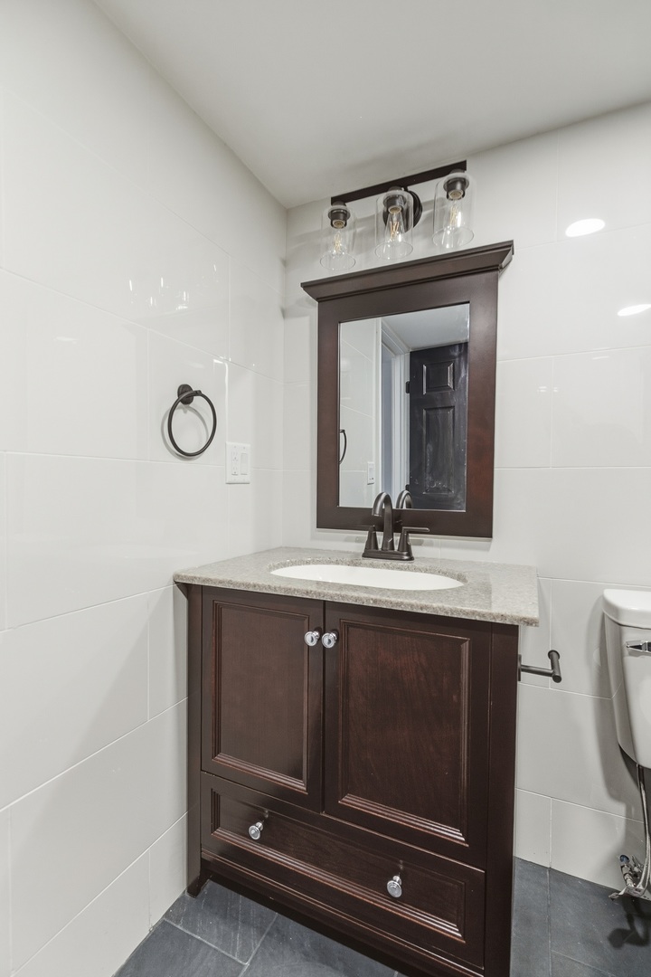 11622 27th Street West Milan, IL 61264 - Photo 21 of 49 a bathroom with a sink mirror and vanity