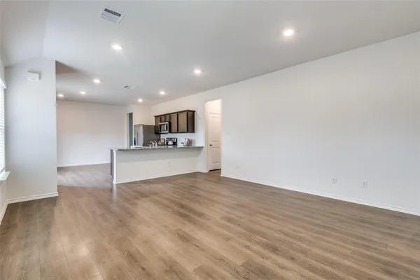 a view of kitchen with kitchen island microwave and stove