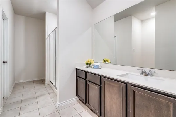 a bathroom with a sink vanity and a mirror