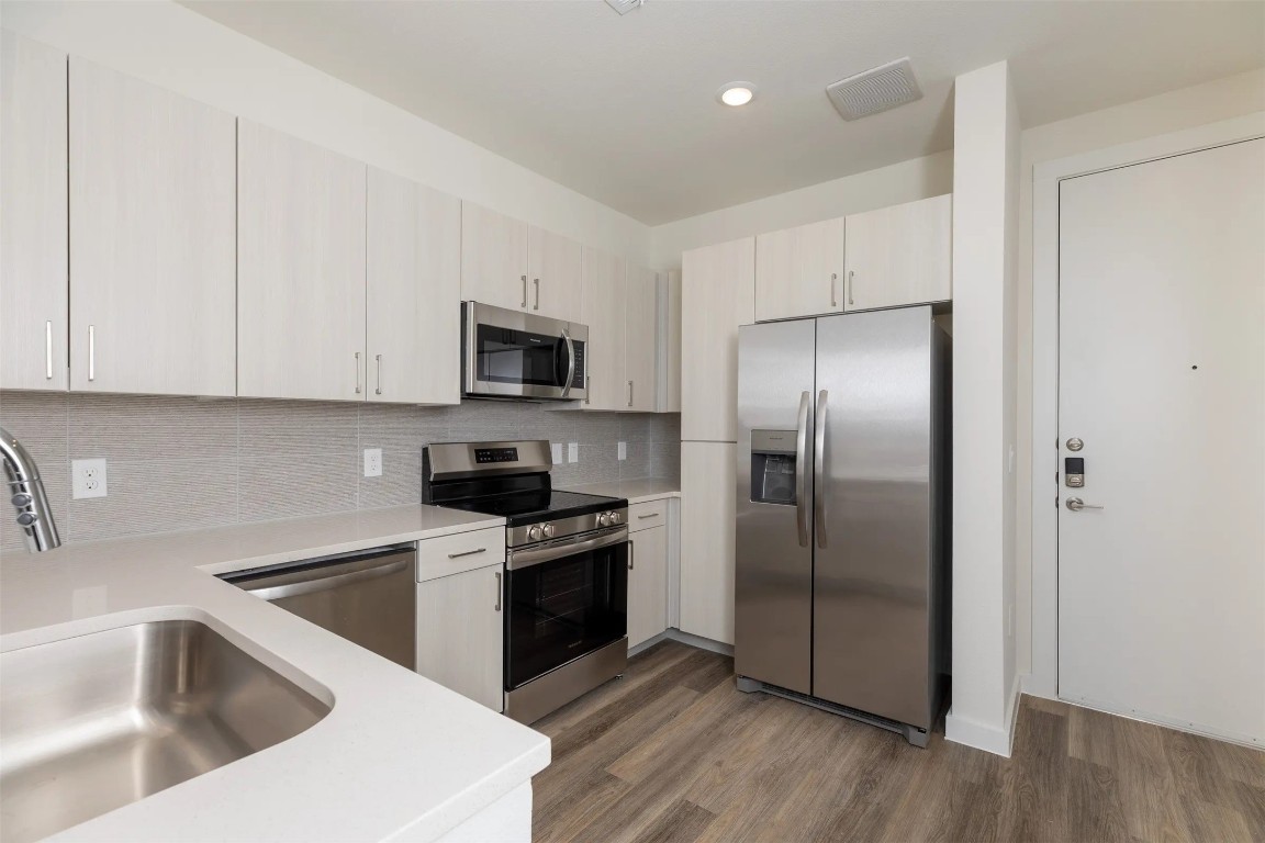 1690 North Loop, Unit 128 Houston, TX 77009 - Photo 9 of 28 a kitchen with a refrigerator sink and microwave