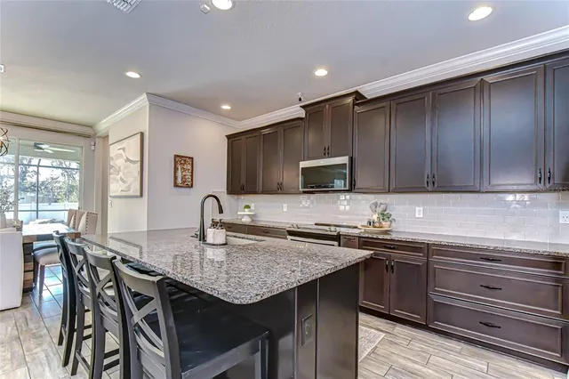 a kitchen with a sink a stove cabinets counter space and appliances