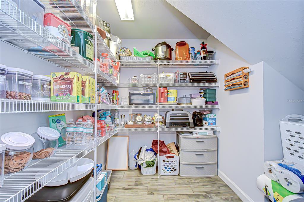 11724 Wrought Pine Loop Riverview, FL 33569 - Photo 15 of 44 a workspace with furniture and a book shelf