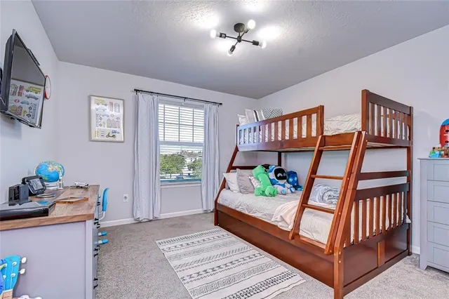 a bedroom with furniture and a window
