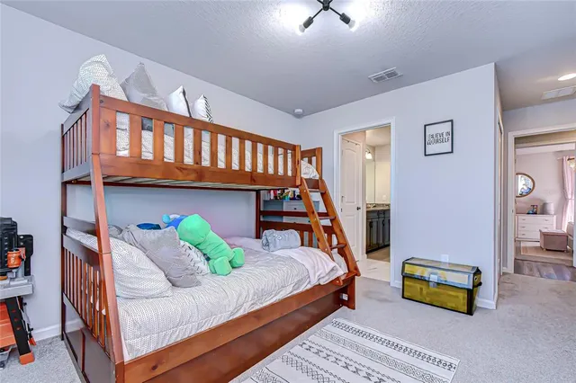 a bedroom with a bed and a couch