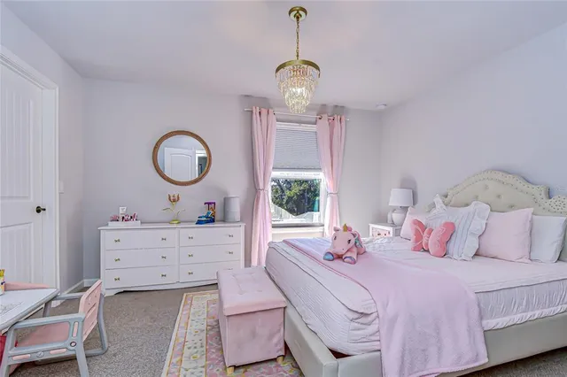 a bedroom with a bed and chandelier