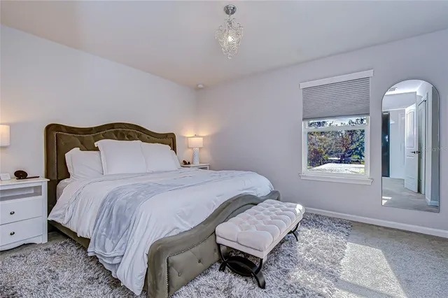 a bedroom with bed and window