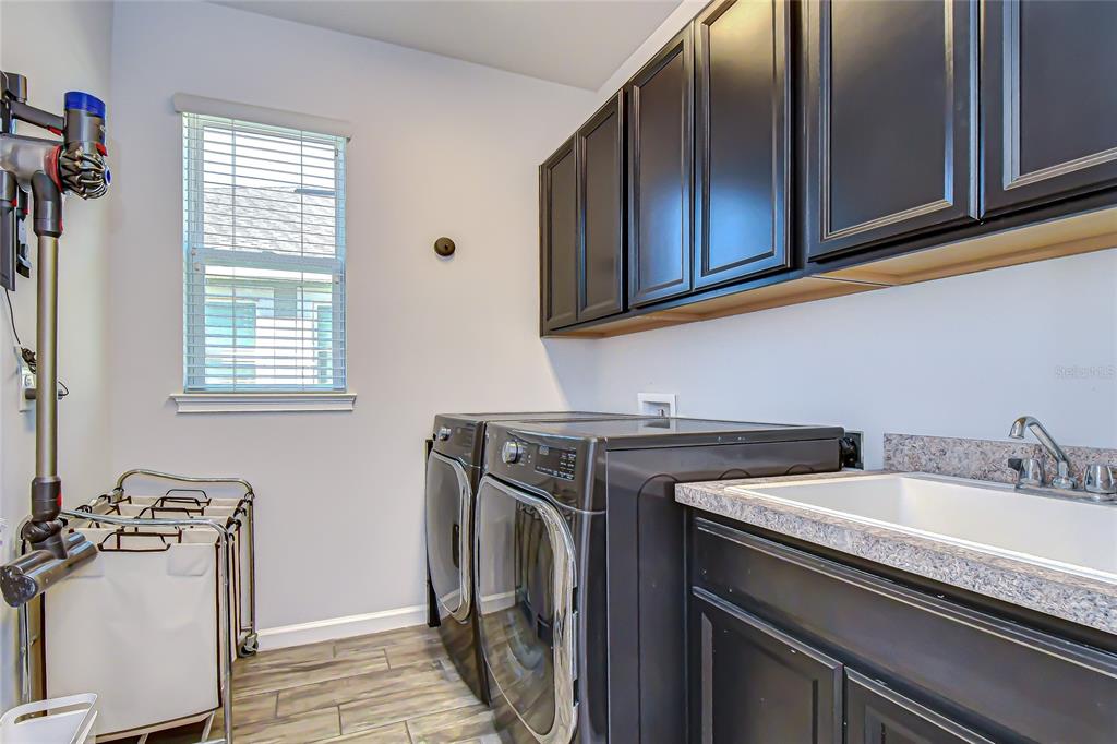 11724 Wrought Pine Loop Riverview, FL 33569 - Photo 31 of 44 a utility room with sink dryer and washer
