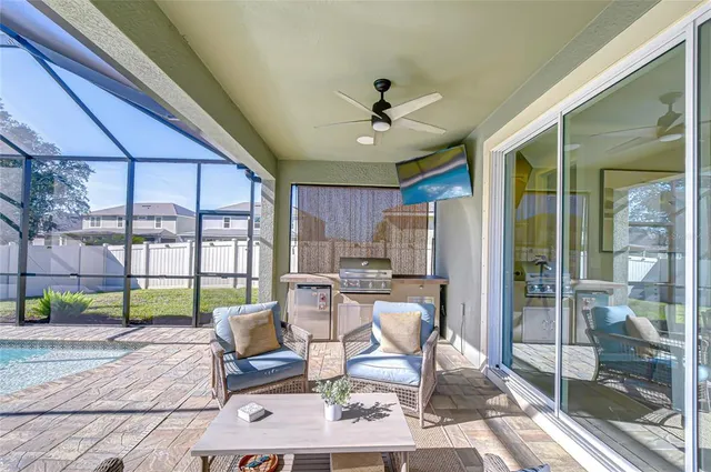 a living room with furniture and a floor to ceiling window