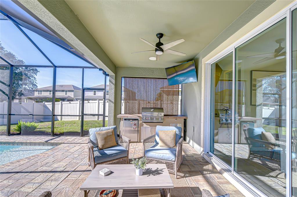11724 Wrought Pine Loop Riverview, FL 33569 - Photo 32 of 44 a living room with furniture and a floor to ceiling window