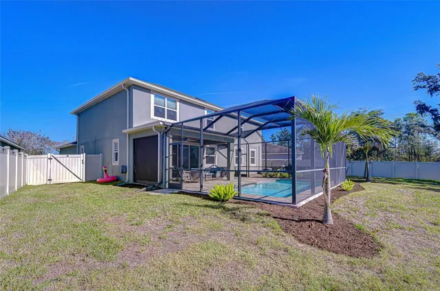 a view of a house with swimming pool and sitting area