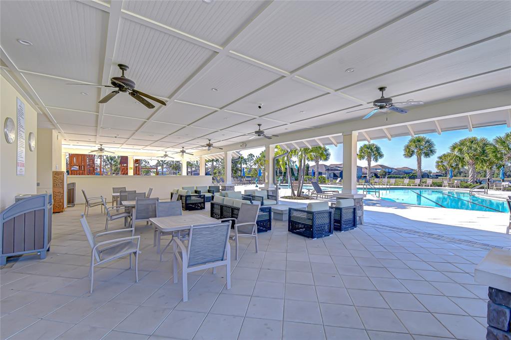 11724 Wrought Pine Loop Riverview, FL 33569 - Photo 40 of 44 a view of a patio with dining table and chairs