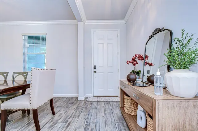 a room with furniture a potted plant and a wooden floor