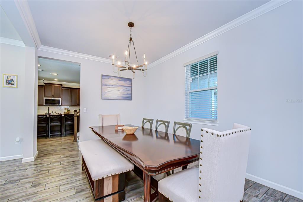 11724 Wrought Pine Loop Riverview, FL 33569 - Photo 7 of 44 a view of a dining room with furniture and wooden floor