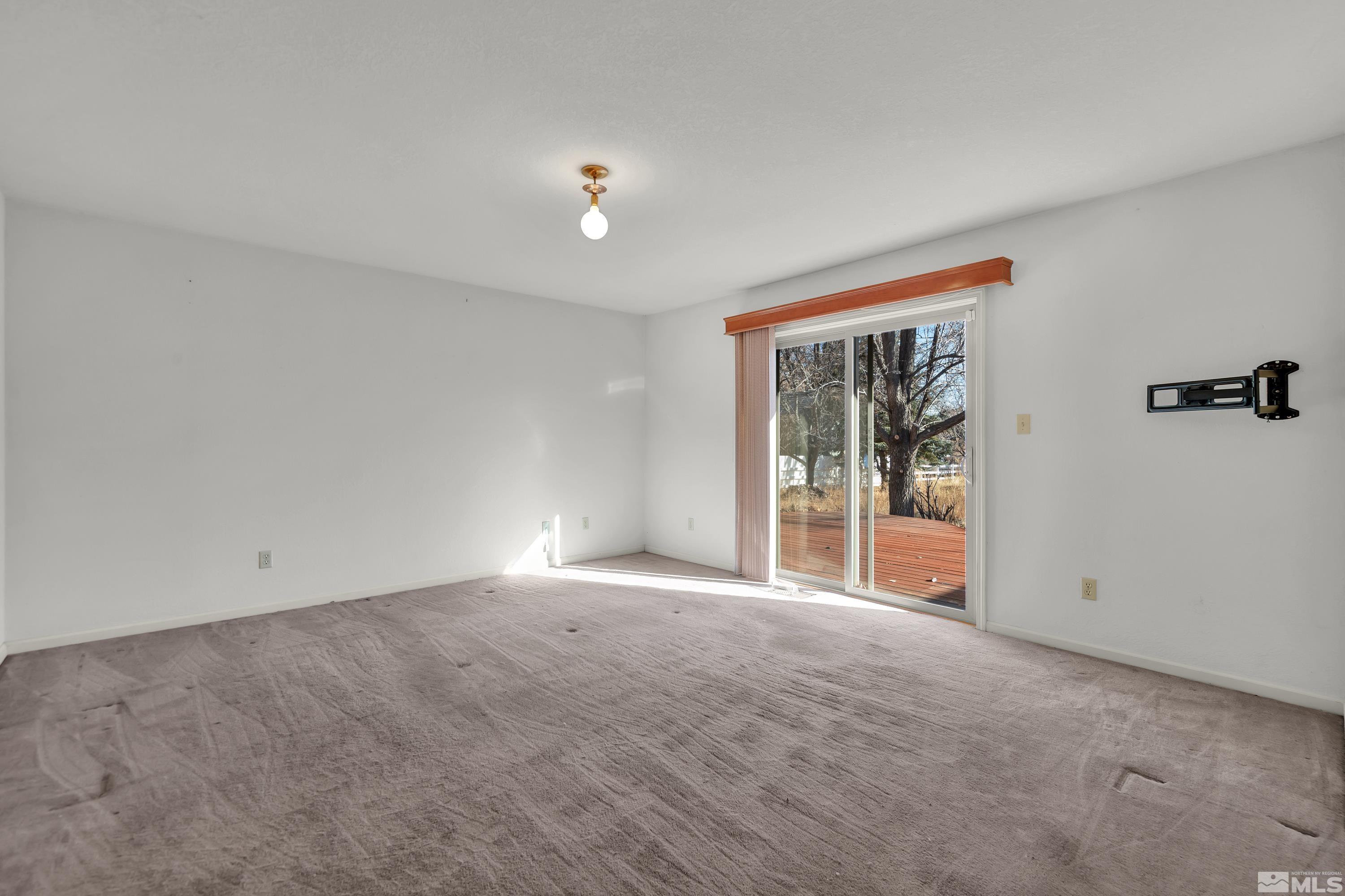 1105 West Huffaker Lane Reno, NV 89511 - Photo 8 of 20 a view of an empty room with a window