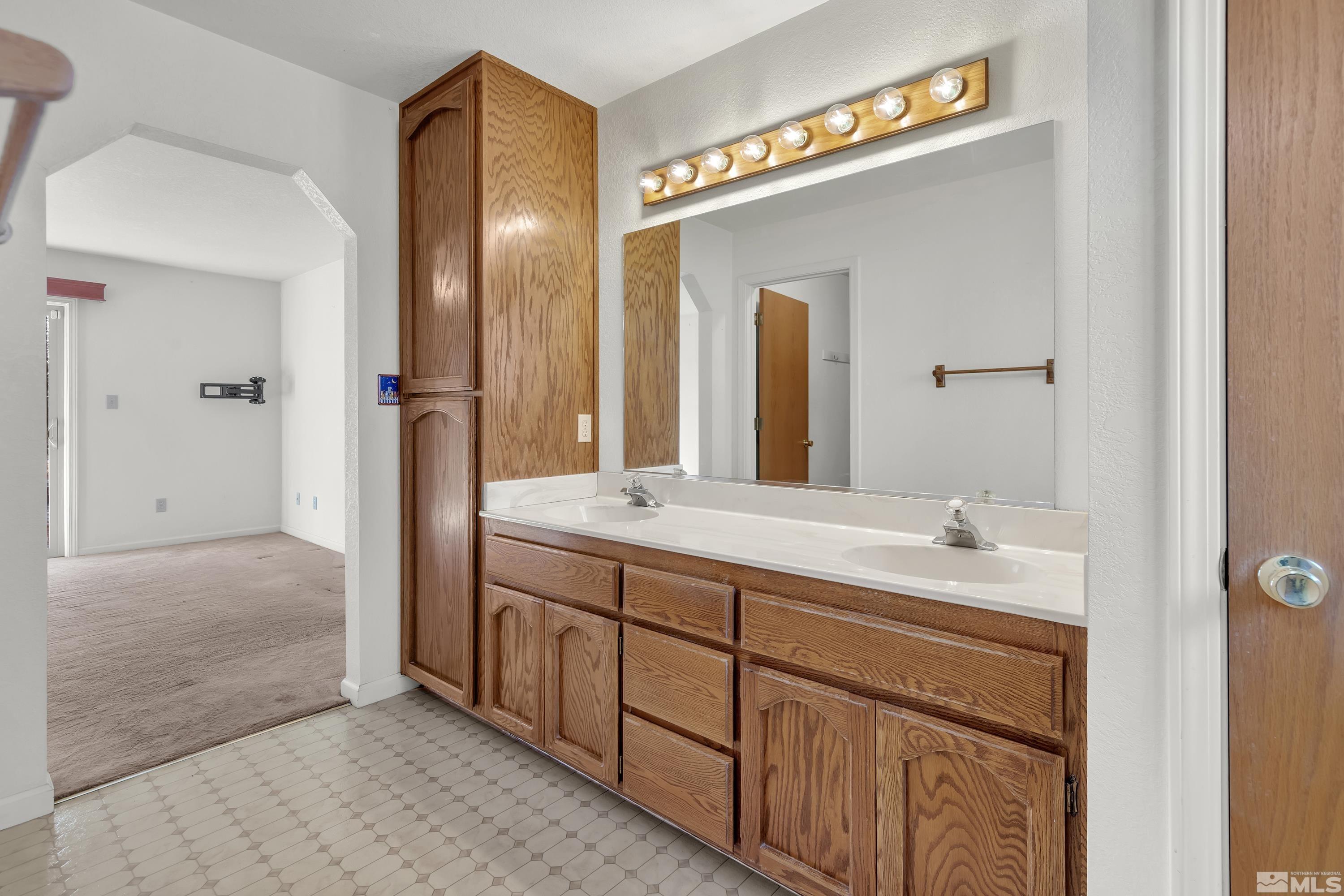 1105 West Huffaker Lane Reno, NV 89511 - Photo 9 of 20 a spacious bathroom with a double vanity sink and a mirror