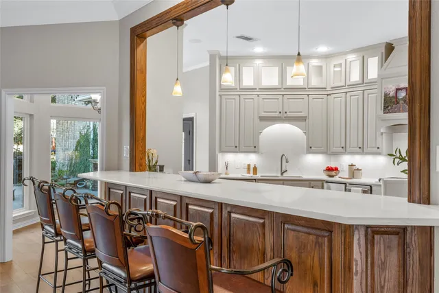 a very nice looking dining room with a large dining table and chairs