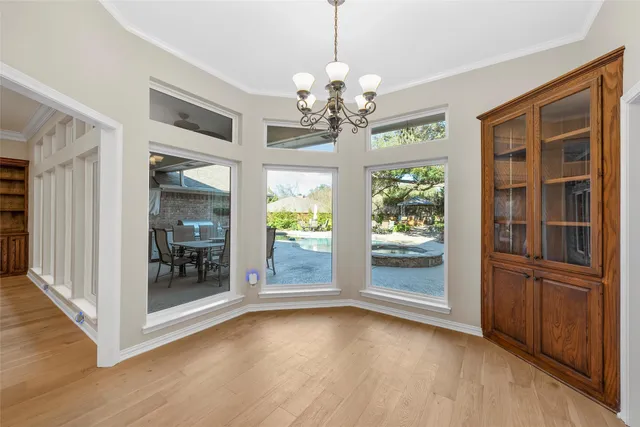 a view of a room with window wooden floor and front door