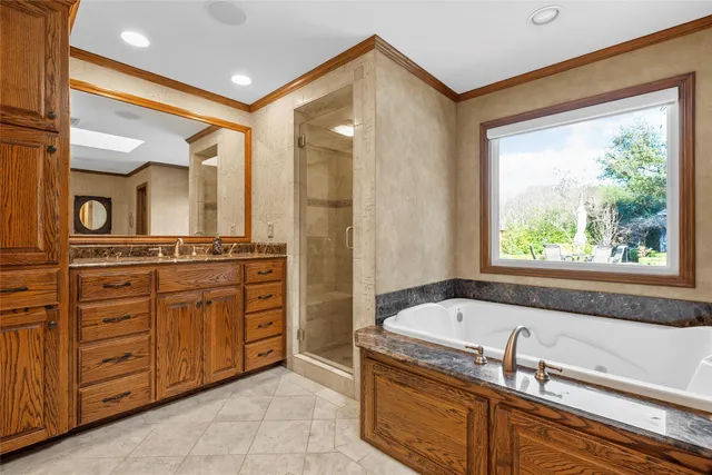 a bathroom with a tub sink and mirror