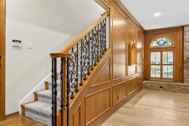 a view of an entryway with wooden floor and stairs