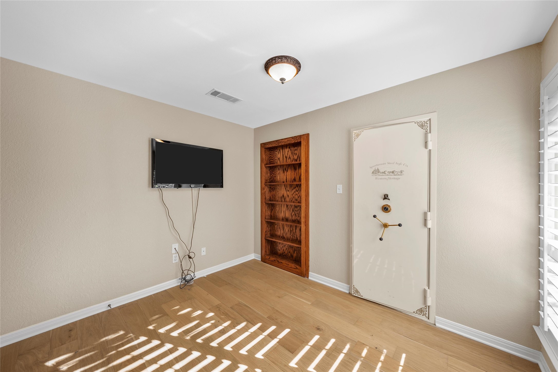 3740 Chimney Ridge Drive Waco, TX 76708 - Photo 28 of 45 a view of a livingroom with wooden floor and a flat screen tv