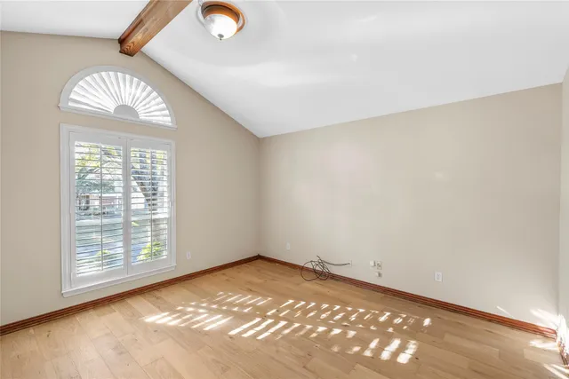 an empty room with a chandeliers fan