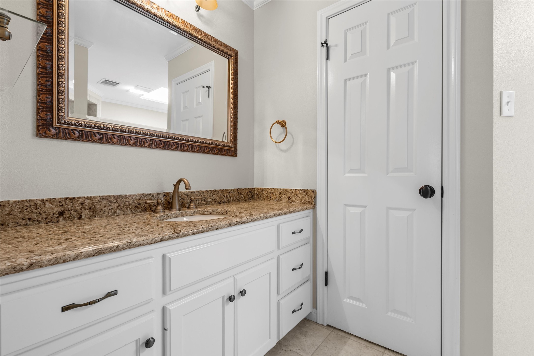3740 Chimney Ridge Drive Waco, TX 76708 - Photo 38 of 50 a bathroom with a granite countertop sink and a mirror