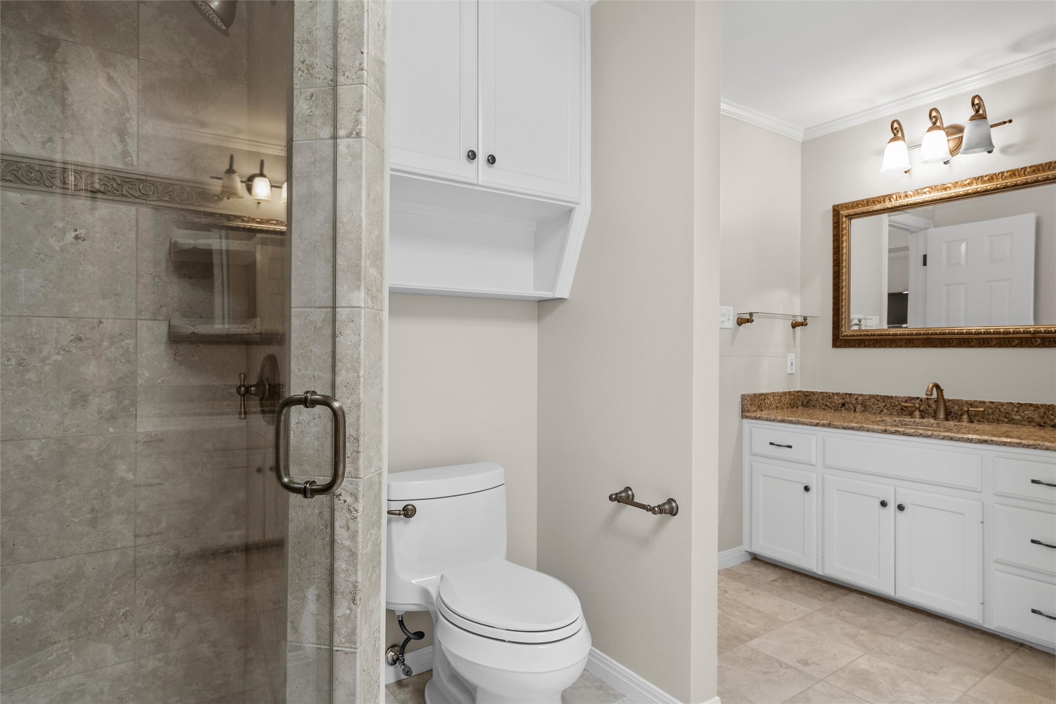 3740 Chimney Ridge Drive Waco, TX 76708 - Photo 40 of 50 a bathroom with a granite countertop toilet sink and a mirror