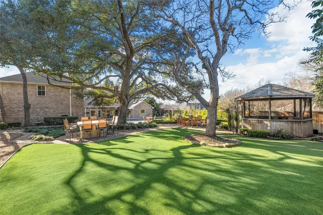 a view of yard with swimming pool and sitting area