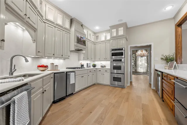 a kitchen with stainless steel appliances a stove sink and cabinets