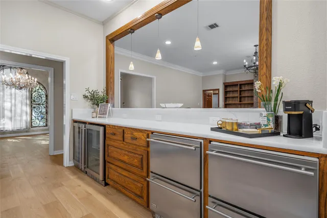 a kitchen with stainless steel appliances granite countertop a sink and a refrigerator