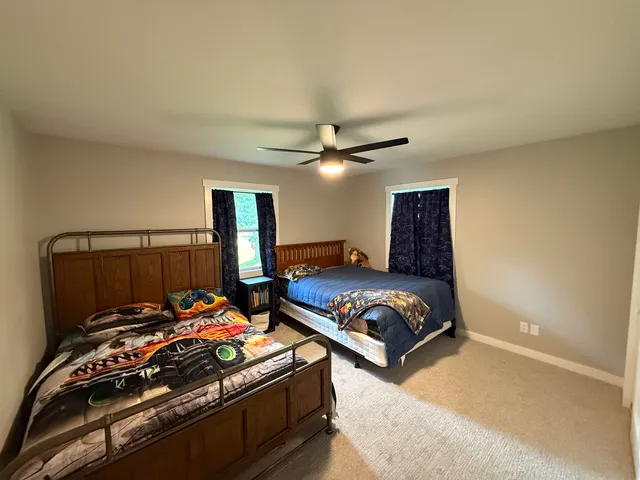 a bedroom with bed and a chandelier