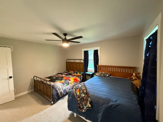 a bedroom with bed and a window