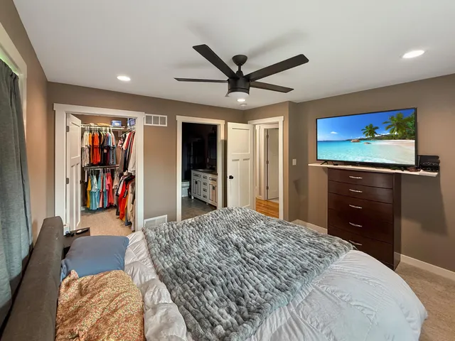 a bed room with a bed and a flat screen tv