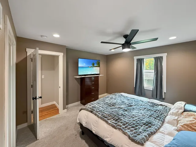 a bedroom with a large bed and a chandelier