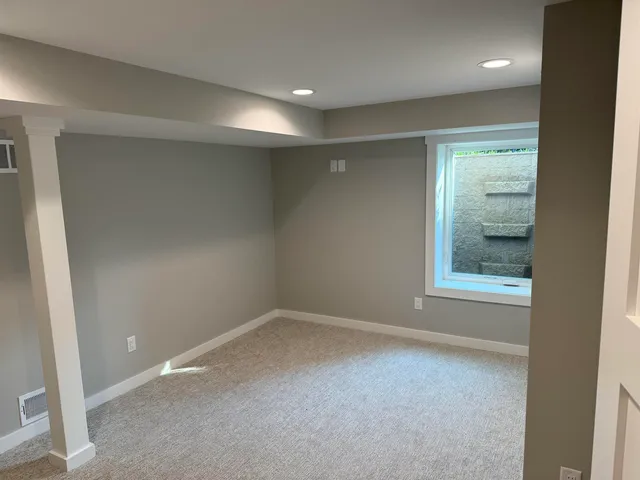 a view of an empty room with a window