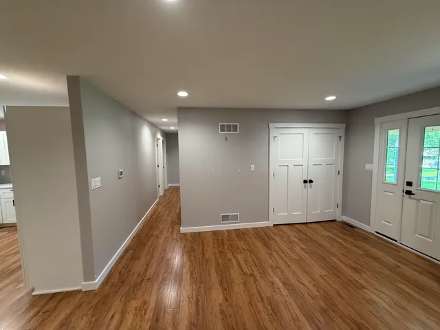 a view of hallway with wooden floor