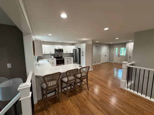 a dining room with furniture and wooden floor